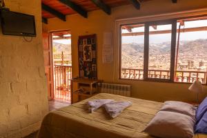 a bedroom with a bed and a window at Samay Wasi Hostel I in Cusco