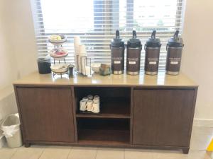 a counter with four bottles of wine in a room at Sonesta Essential IAH Airport JFK Boulevard - Newly Renovated in Houston