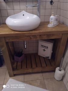 a white sink on a wooden table in a bathroom at Casa Schobeln in Braşov
