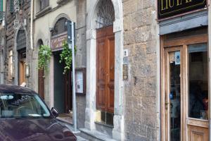 a building with a wooden door on a street at Palazzo Vecchio Apartments by Mmega in Florence