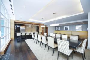 a dining room with a long table and chairs at PlanURstay- Mississauga Downtown Square One Shopping Centre in Mississauga