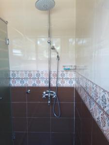 a bathroom with a shower with a glass door at Emmaus Guesthouse Kampala in Kampala