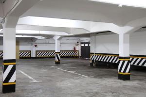 an empty parking lot with black and white columns at Grand Hotel Santa Teresita in Mar del Plata
