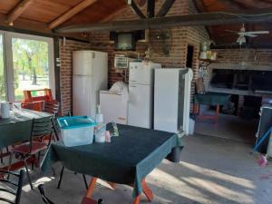 a room with tables and refrigerators in a building at Hotel y Cabañas Dakota in Concordia