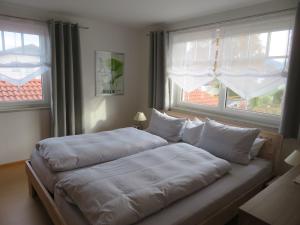 מיטה או מיטות בחדר ב-Ferienwohnung Anderl