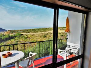 a view from a balcony with a table and chairs at Casa do Mar in Santo Isidoro