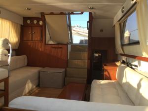 a living room with a couch and stairs in a boat at Alojamiento Singular en Baiona in Baiona