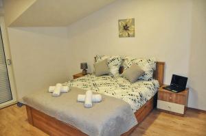 a bedroom with a bed with two candles on it at Apartman Đoni in Split