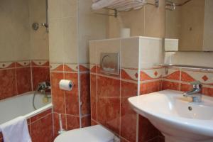 a bathroom with a toilet and a sink and a tub at Metropol in Paris