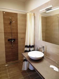 a bathroom with a sink and a shower at Mediterrán Villa Kecskemét in Kecskemét
