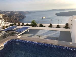 a swimming pool with a view of the water at Altana Cliffside Villas in Imerovigli