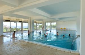 a group of people in a swimming pool at Alfagar Alto da Colina in Albufeira