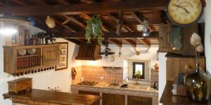 a kitchen with a counter and a clock on the wall at Quinta dos Canteiros in Fátima