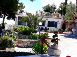 a house with a lot of plants in front of it at Residence Maresol in Vieste