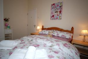 a bed with a teddy bear sitting on top of it at Saltburn Holidays 1 Park View Loftus in Loftus