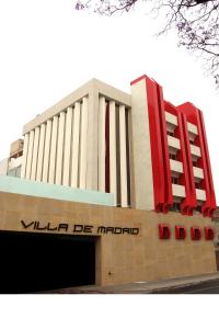ein Gebäude mit einem großen roten Stuhl darüber in der Unterkunft Hotel Villa de Madrid in Mexiko-Stadt