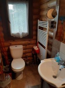 a bathroom with a toilet and a sink at Wooden House in Veria in Tagarochórion
