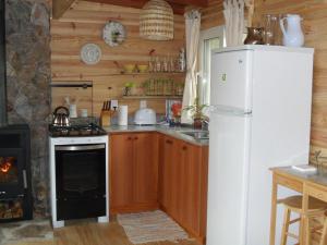 a kitchen with a white refrigerator and a stove at El Ahora in El Eden