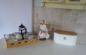 a kitchen counter with a tea set on a counter top at Tweed Cottage in Jedburgh