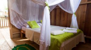 a bedroom with a bed with a canopy at La Ceiba, Amazonas in Leticia