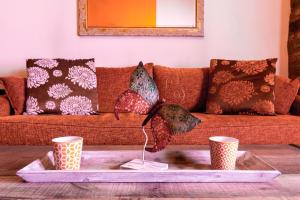 a living room with a couch with pillows and a table at Katsarou Apartments in Arachova