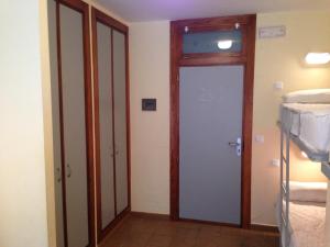 a room with a door and two bunk beds at Albergue De Puntas De Calnegre in Calnegre