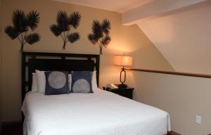 a bedroom with a large white bed with blue pillows at The Cove of Lake Geneva in Lake Geneva