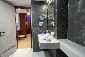 a bathroom with a sink and a mirror at Hotel Solun in Trieste