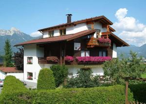 a house with flowers on the balconies of it at Haus Müller in Reutte