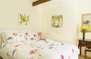 a bedroom with a bed with towels on it at The Neuadd Cottages in Crickhowell