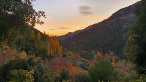a sunset over a valley with trees and mountains at Saluda Alta in Castril