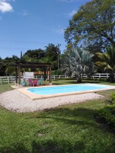 a swimming pool with a gazebo next to a yard at Villa Sueño Potrero in Potrero