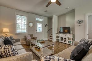 a living room with two couches and a tv at Barefoot Cottages #C56 in Highland View