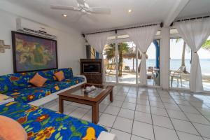 a living room with a couch and a table at Del Sol Beachfront in Akumal