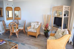 a living room with a couch and chairs and a tv at Maui Vista 1313 in Kihei