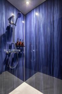 a bathroom with a shower with blue curtains at slash kawasaki in Kawasaki
