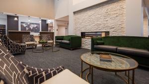 a lobby with couches and tables and a fireplace at Best Western Plus Morden in Morden