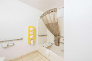 a bathroom with a shower curtain and a toilet at Motel 6-Gastonia Charlotte I-85 in Gastonia +22 photos