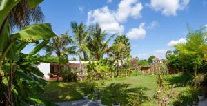 a yard with palm trees and a house at Angkor Private villa Siem Reap in Siem Reap