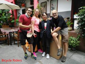 a group of people posing for a picture at Wenjun Courtyard Hotel ---5 mins walk from Tonghuimen metro station, near Tianfu square, close by culture park and Sichuan opera house, English speaking service, local tours in Chengdu