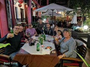 a group of people sitting at a table in a restaurant at Wenjun Courtyard Hotel ---5 mins walk from Tonghuimen metro station, near Tianfu square, close by culture park and Sichuan opera house, English speaking service, local tours in Chengdu