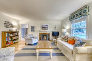 a living room with a couch and a fireplace at Kennebunk Family Cottage in Kennebunk