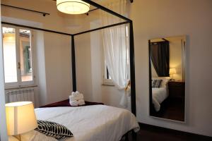 1 dormitorio con espejo grande y cama en Suite Lungara, en Roma