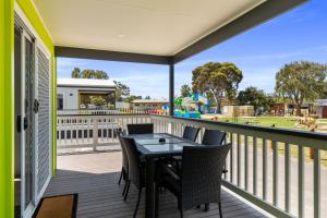 
a patio area with a table and chairs at Victor Harbor Holiday & Cabin Park in Victor Harbor
