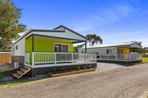 a house with a green and white at Victor Harbor Holiday Park in Victor Harbor