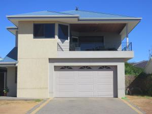 a house with a garage door in front of it at Kalbarri Riverfront Unit in Kalbarri