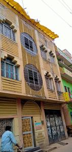 a man riding a bike in front of a building at Hostel Relax Homestay in Gaya