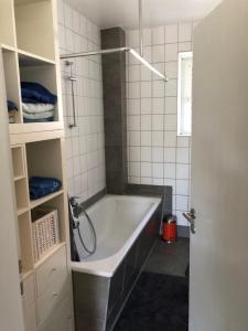 a bathroom with a bath tub and a shower at Sieben-Berge-Ferienwohnungen in Alfeld +75 photos