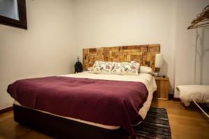a bedroom with a large bed with a brick wall at Copo in Sierra Nevada