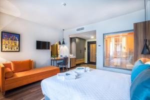 a hotel room with a bed and a couch at Signature Ortahisar Hotel & SPA in Ürgüp